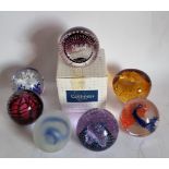 Seven glass paperweights, including Caithness 2000. boxed, Caithness Cauldron, T.V.G. limited