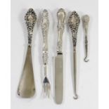 A silver handled button hook and shoe horn, Chester 1910, a small button hook, Birmingham 1911 and a