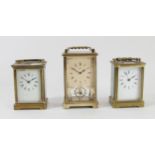 Three mid 20th Century 8 day carriage clocks, brass cased, bevel edged glass panels, enameled