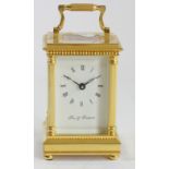 Fox & Simpson, a gilt brass Anglais Riche cased carriage time piece, the white enamel dial with