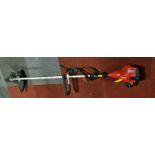 A Homelite Mighty Lite petrol garden strimmer,