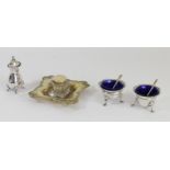 A silver pair of salt pots, Birmingham 1908, with matching silver spoons and blue glass liners, an