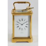 Winder, Eastbourne, a gilt brass Corniche cased striking carriage clock, white enamel dial with