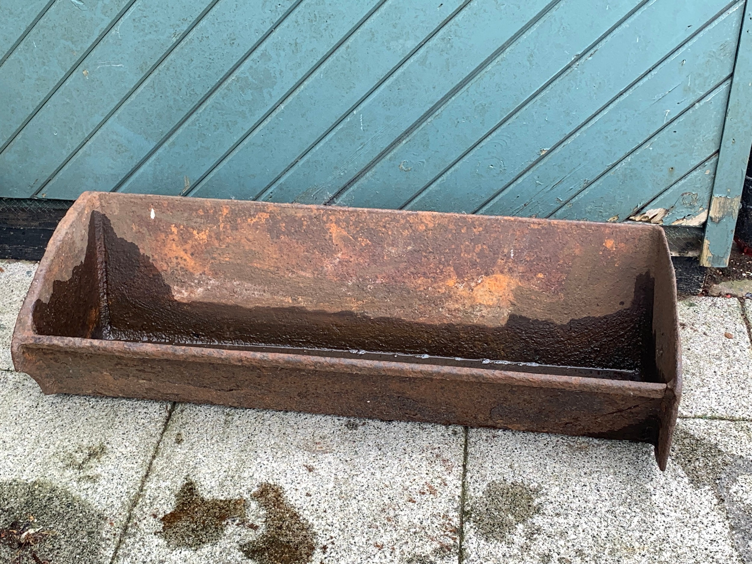 A cast iron trough, 91cm x 23cm x 34cm