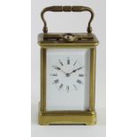 A late 19th century French Corniche cased brass striking and repeating carriage clock, white