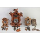 A collection of four Black Forest style cuckoo clocks, in need of attention. (4)