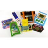 Seven electronic handheld and tabletop games, to include Bambino Master-Blaster Station, Baseball,