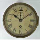 A Smith Astral bulk head clock, brass case, hinged glazzed door, painted dial with Roman numerals,