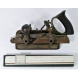 A Stanley No45 combination plane, cast metal with floral pattern and wooden furniture, together with