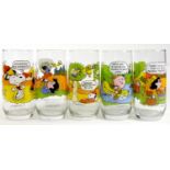 A set of five McDonalds USA Camp Snoopy highball glasses, depicting comic strips from Snoopy,