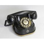 A RTT Telephone , with brass carry handle, painted metal casing and Bakelite receiver, c1950s, paper