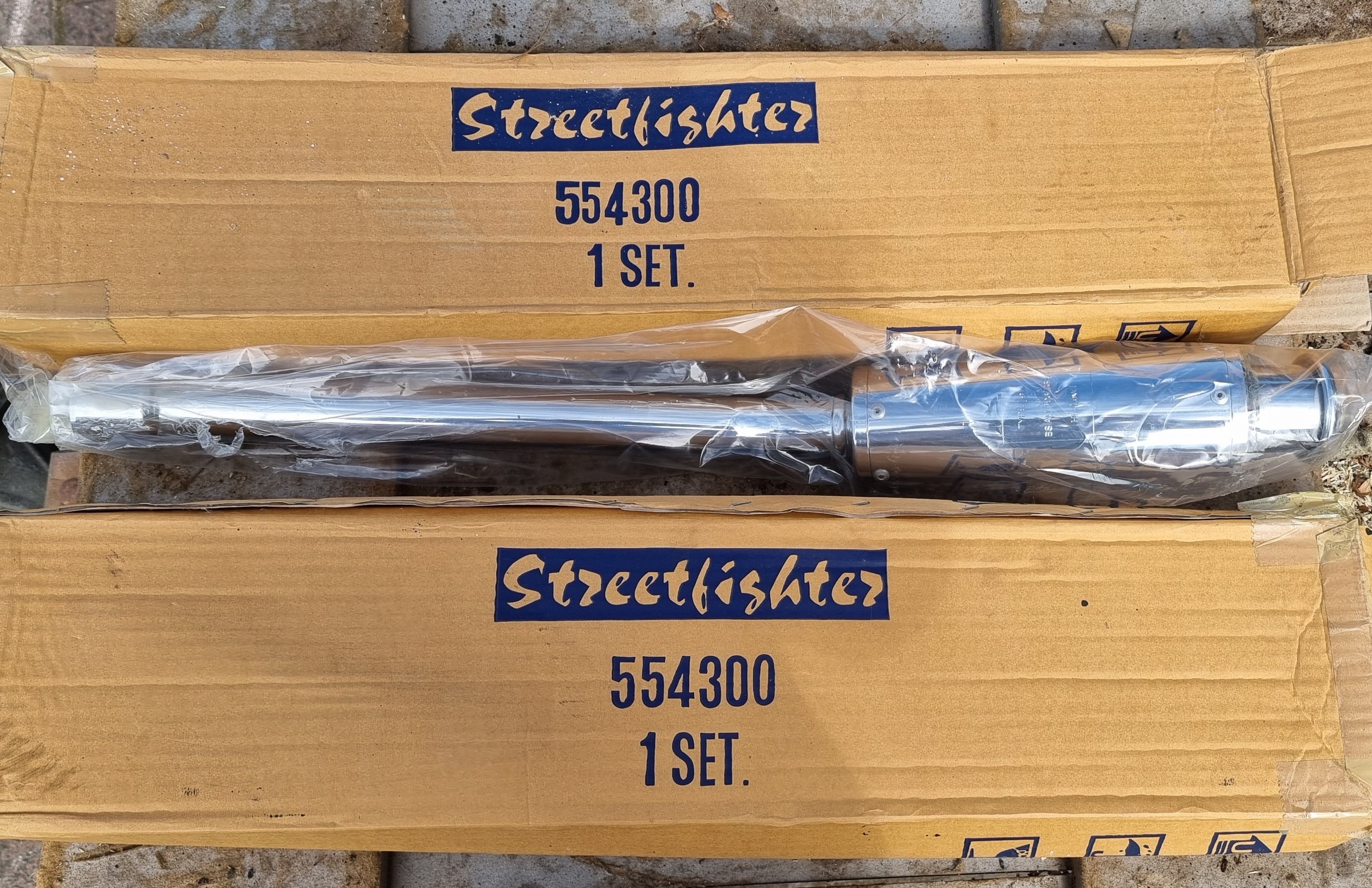 A pair of new old stock Streetfighter 554300 exhaust pipes