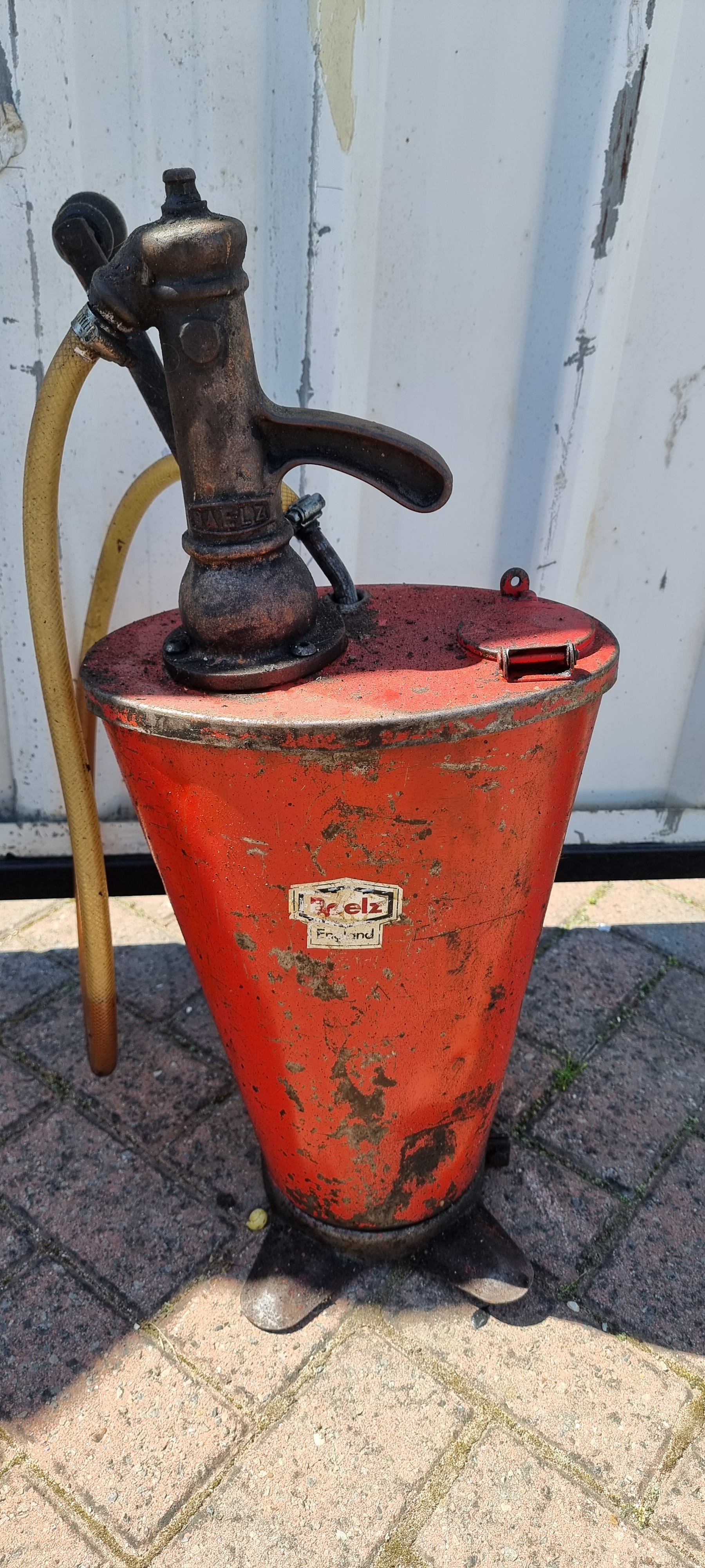 A red Baelz oil dispenser
