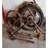 A believed 1930's AJS frame, two other frames two wheels and a NOS tyre