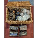 Four leather vintage tool bags, various leather belts and buckles, contained in a wicker basket