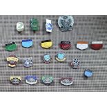 A collection of 20 enamel race track lapel badges including Le Mans, Monza, Brands Hatch, Oulton,