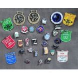 A collection of 23 Isle of Man TT enamel lapel badges, c.1960/70's