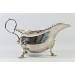 A silver gravy boat, by Walker & Hall, Sheffield 1937, with gadrooned border, leaf capped handle,