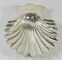A Victorian silver shell shape butter dish, by Walker & Hall, Sheffield 1892, raised on shell