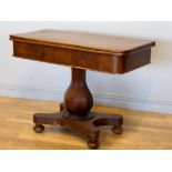 A 19th century fold over side table, with swivel top, raised on an octagonal baluster stem,