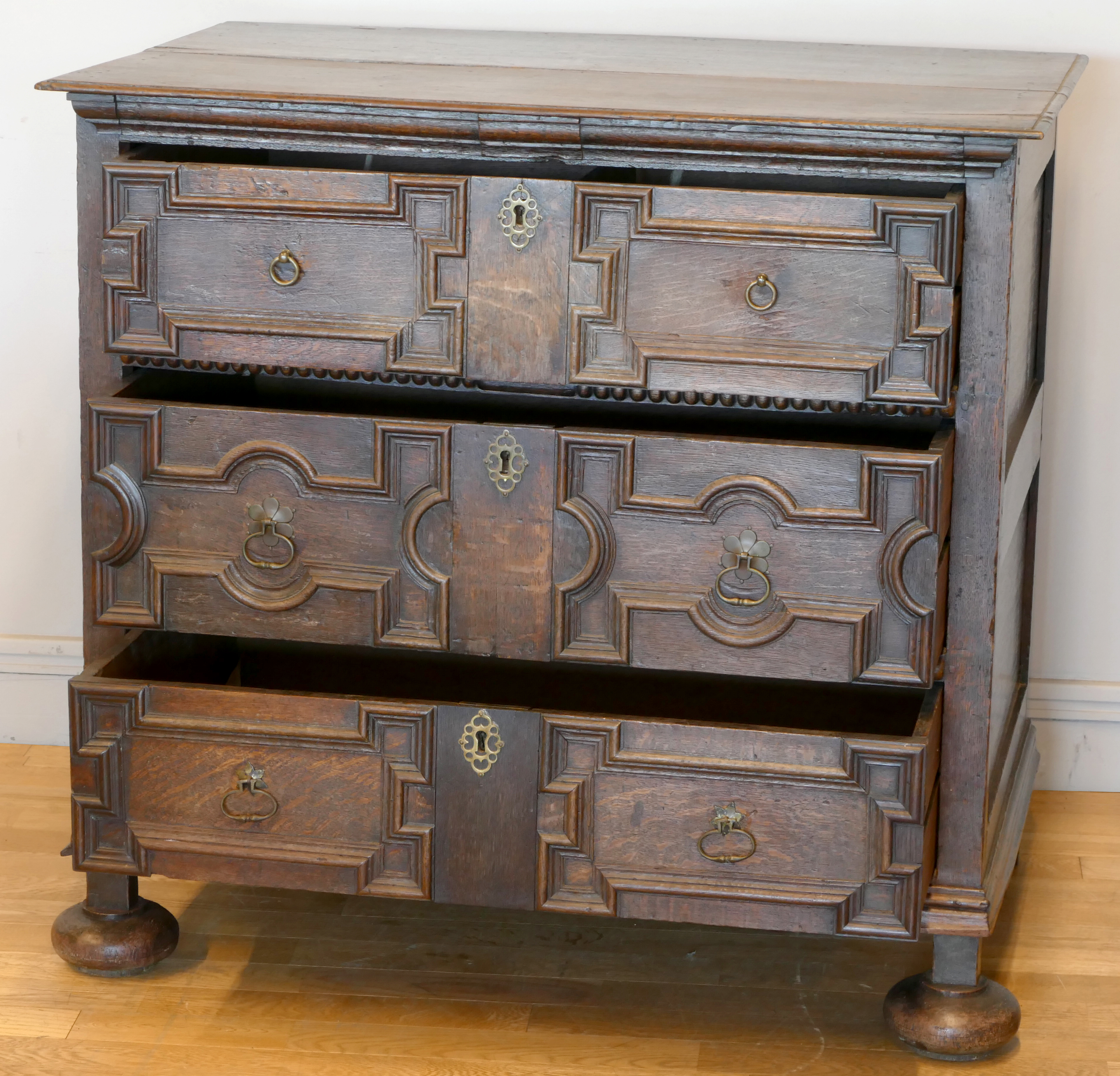 A late 17th century oak chest of three long drawers, two plank top over geometric moulded drawer - Image 4 of 5