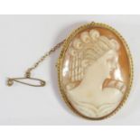 A 9ct gold mounted oval shell cameo brooch, depicting a lady in profile, the rope twist frame