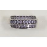 A 9ct white gold and three row Tanzanite ring, channel set with brilliant cut stones, O, 5.1gm