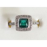 An Art Deco style white gold, synthetic emerald and diamond cluster ring, tests as 9ct, collet set