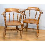 A near pair of Victorian ash and elm captains chairs, scroll arms and turned supports, one stamped