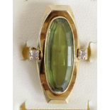 A 14ct gold synthetic green spinel and diamond panel ring, bearing 585 control marks, collet set