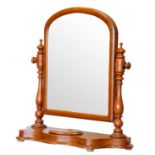 A Victorian arched dressing table mirror, raised on a shaped base with hinged trinket compartment,