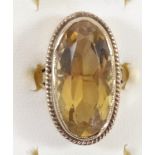 A 9ct gold and citrine dress ring, collect set with an oval mixed cut stone, 23 x 12mm, L, 8.4gm