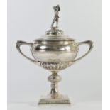 A silver golfing trophy, by Manoah Rhodes, Sheffield 1925, the pull off cover with a golfer in