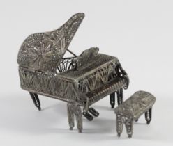 A filigree silver miniature grand piano and stool, apparently unmarked, lift up cover, 53 x 38mm,
