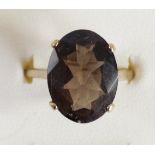 A 9ct gold and smokey quartz ring, claw set with a mixed cut stone, 16 x 12mm, S 1/2, 3.2gm