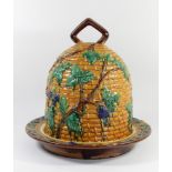 A large majolica pottery beehive stilton dish and cover, possibly Minton, moulded with flowering