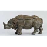 An early 20th century cold painted metal model of a Rhinoceros, the back opening to reveal two