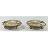 A pair of silver shell shape butter dishes, by Walker & Hall, London 1919, raised on three ball