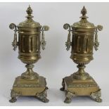 A pair of late 19th century brass garnitures, of twin handled form, raised on a square base with