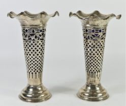 A silver pair of pierced vases by Jay, Richard Attenborough & Co Chester 1907, blue glass liners,