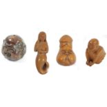 A Japanese wood netsuke of a phallus with face, signed, 4.5cm, a wooden netsuke of the four faced