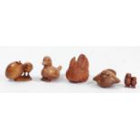 A Japanese wood netsuke of a chick by an egg with another inside, signed, 5cm, and four other wooden