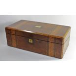 A 19th Century walnut writing slope/box, brass strung with gilt brass escutcheons, lid opening to
