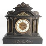 A late 19th century French black slate mantel clock, the ivorine dial to a signed movement, striking