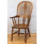 A Victorian ash and elm Windsor high back arm chair, with scroll splat and turned supports, 113cm.