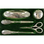 An Edwardian silver manicure set, Birmingham 1909, with embossed decoration, comprising, buffer,