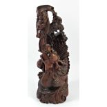 A Chinese carved rootwood statue, depicting a dragon chasing the sacred pearl, 35cm