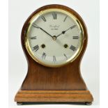 Woodford, a mahogany balloon mantle clock, the white enamel dial signed, the 8 day movement by Franz