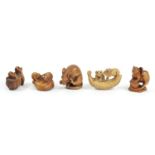 A Japanese wood netsuke of two mice on a mushroom, signed, 4cm and four other wooden netsuke of