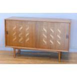 Heal's of London, a vintage walnut sideboard, c.1970's, the sliding doors with incised Zig Zag